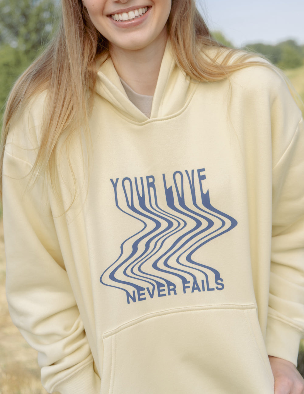 Elevated Faith Love Never Fails Cream Unisex Hoodie