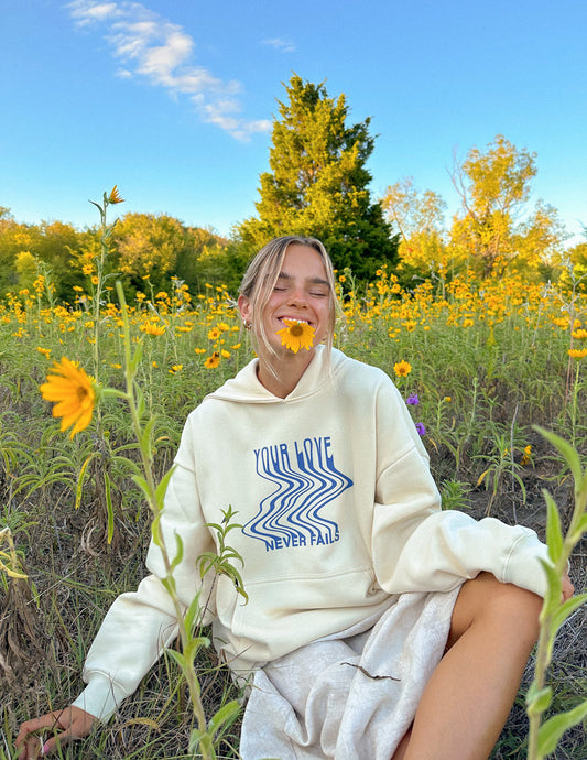 Elevated Faith Love Never Fails Cream Unisex Hoodie